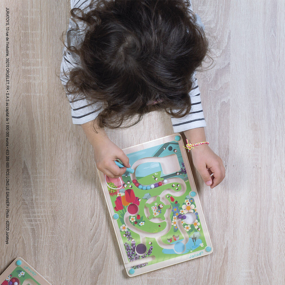 Child playing with a colorful puzzle on a wooden floor