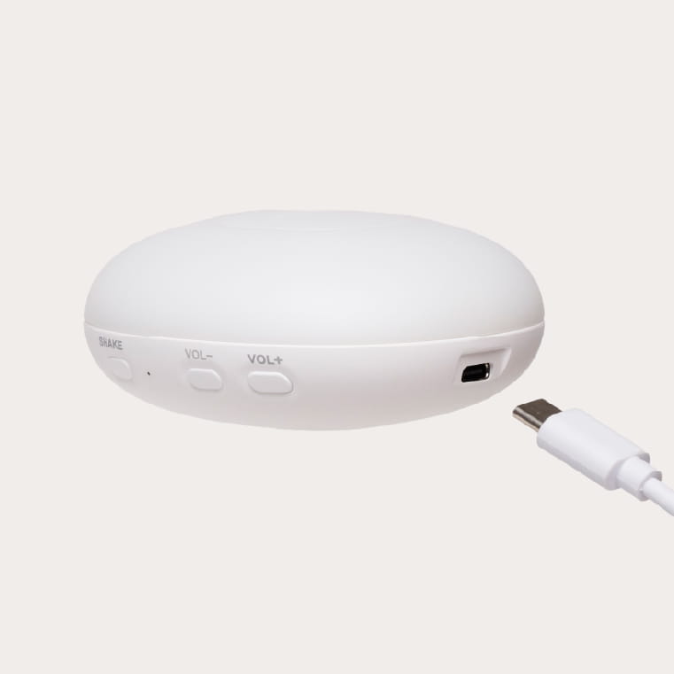 White electronic device with USB cable on a light gray background